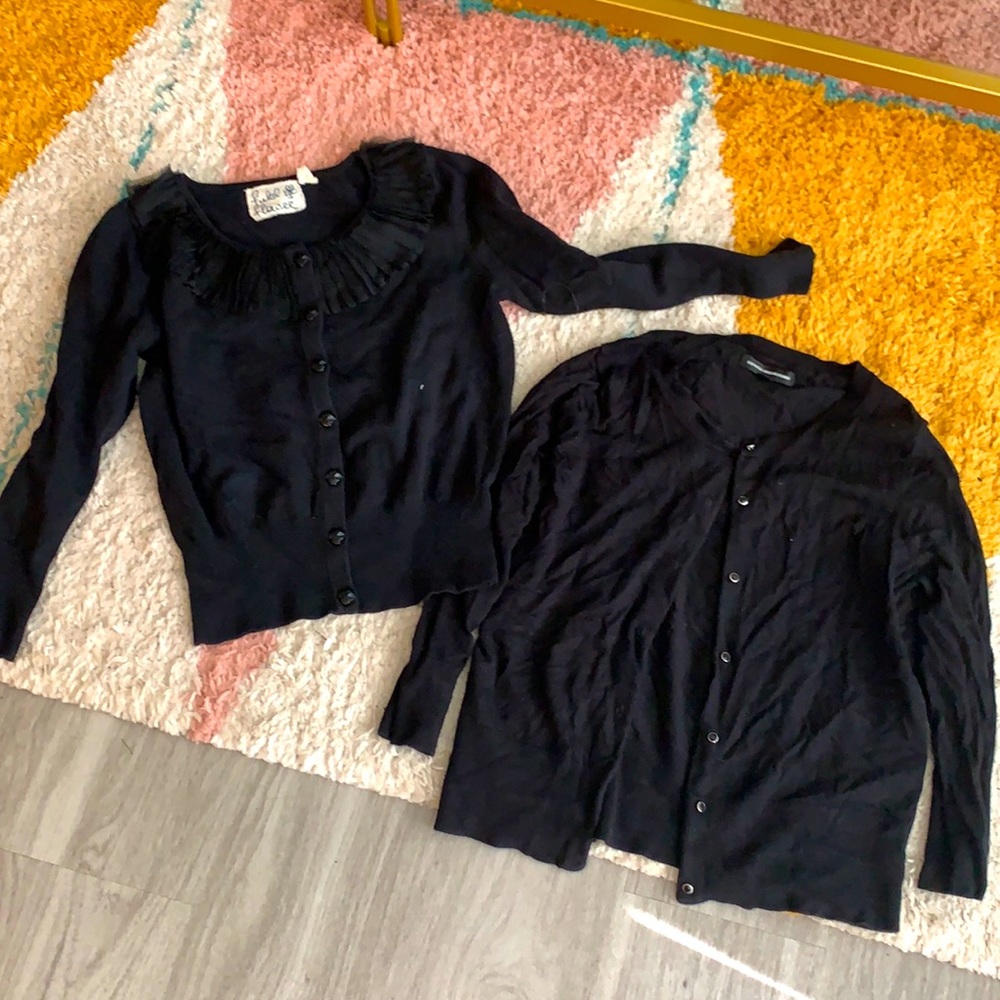 Two black long sleeve button down sweaters